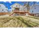 Exterior view of the home showcasing a spacious backyard and wooden deck at 10941 Parker Vista Rd, Parker, CO 80138