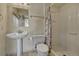 Functional bathroom featuring a pedestal sink, toilet, and a walk-in shower at 10941 Parker Vista Rd, Parker, CO 80138