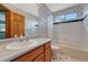 Bathroom featuring a white sink, matching tile accents, and a tub and shower at 10941 Parker Vista Rd, Parker, CO 80138
