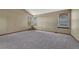 Bright bedroom featuring plush carpet, neutral paint, and large windows at 10941 Parker Vista Rd, Parker, CO 80138
