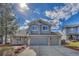 Well-manicured lawn complements this exterior, which features a two-car garage and classic architectural design at 10941 Parker Vista Rd, Parker, CO 80138