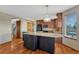 Open kitchen with granite countertops, dark cabinetry, and hardwood floors at 10941 Parker Vista Rd, Parker, CO 80138
