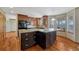 Modern kitchen featuring an island with a granite countertop, black appliances, and custom cabinetry at 10941 Parker Vista Rd, Parker, CO 80138