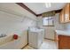 Well-equipped laundry room with a utility sink, washer, dryer, and storage cabinets at 10941 Parker Vista Rd, Parker, CO 80138