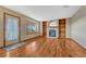Inviting living room featuring a cozy fireplace with built-in shelves and hardwood floors at 10941 Parker Vista Rd, Parker, CO 80138