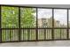 Enclosed balcony area showing trees and another building at 14152 E Linvale Pl # 408, Aurora, CO 80014