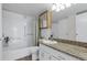Bathroom with tub and shower combo, vanity and granite countertop at 14152 E Linvale Pl # 408, Aurora, CO 80014
