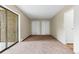 Bedroom featuring two closets, carpeting, and a glass patio door at 14152 E Linvale Pl # 408, Aurora, CO 80014