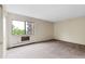 Bright bedroom features a large window, neutral walls, and plush carpeting at 14152 E Linvale Pl # 408, Aurora, CO 80014