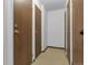 Hallway featuring multiple apartment doors and neutral-toned flooring, providing access to residences at 14152 E Linvale Pl # 408, Aurora, CO 80014