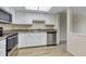 Well-lit kitchen featuring modern appliances and white cabinetry at 14152 E Linvale Pl # 408, Aurora, CO 80014