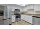 Bright kitchen with white cabinets, granite counters, and stainless steel appliances at 14152 E Linvale Pl # 408, Aurora, CO 80014