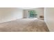 Spacious living room featuring carpet and large sliding glass doors to a balcony at 14152 E Linvale Pl # 408, Aurora, CO 80014