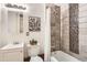 Updated bathroom featuring a tiled shower, modern vanity, and decorative accents for a stylish look at 1425 N Washington St # 104, Denver, CO 80203