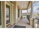 Inviting covered porch with classic columns, neutral tones, and a hanging light fixture, perfect for relaxing outdoors at 1425 N Washington St # 104, Denver, CO 80203