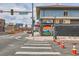 Street view of a commercial building in Denver with colorful street art and a pedestrian crosswalk at 1425 N Washington St # 104, Denver, CO 80203