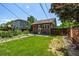 Backyard view featuring a well-maintained lawn and patio with lounge chairs at 4654 Bryant St, Denver, CO 80211