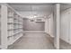 A basement room with carpet flooring, exposed beams, and built in shelving at 4654 Bryant St, Denver, CO 80211
