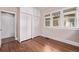 Bedroom features hardwood floors, closet, and three windows at 4654 Bryant St, Denver, CO 80211