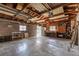 Large garage with concrete flooring, exposed beams, and windows for natural light at 4654 Bryant St, Denver, CO 80211