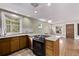 Well-lit kitchen features stainless steel appliances, granite countertops and multiple windows at 4654 Bryant St, Denver, CO 80211