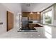 Bright kitchen with stainless refrigerator, granite countertops, tiled backsplash and gas range at 4654 Bryant St, Denver, CO 80211
