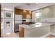 Cozy kitchen with stainless steel refrigerator, granite countertops and a gas range at 4654 Bryant St, Denver, CO 80211