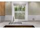 Kitchen window view featuring stainless steel faucet and granite countertops at 4654 Bryant St, Denver, CO 80211