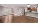 Open concept living room with hardwood floors flowing into the kitchen at 4654 Bryant St, Denver, CO 80211
