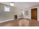 Spacious living room with hardwood flooring, chandelier and multiple windows at 4654 Bryant St, Denver, CO 80211