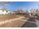 Large fenced back yard features patio, chicken coop and mature trees at 1811 S Norfolk St, Aurora, CO 80017