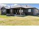 An inviting outdoor space featuring a manicured lawn, covered patio and an outdoor kitchen at 740 W County Road 10E, Berthoud, CO 80513