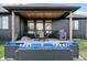 An inviting covered patio complete with outdoor seating, a grill, and a wood ceiling at 740 W County Road 10E, Berthoud, CO 80513