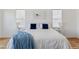 Bright bedroom with white walls, wood floor, and two windows with light-filtering shades at 740 W County Road 10E, Berthoud, CO 80513