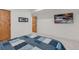 A comfortable bedroom featuring neutral walls and cozy blue-patterned bedding at 740 W County Road 10E, Berthoud, CO 80513