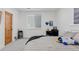 Well-lit bedroom with a desk area, window with blinds, and neutral-toned decor at 740 W County Road 10E, Berthoud, CO 80513
