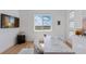 Bright bedroom highlighting a large window with scenic views, wood floors, and a marble table at 740 W County Road 10E, Berthoud, CO 80513