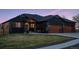 Charming home with a well-manicured lawn, modern wooden garage doors, and a cozy front patio area at 740 W County Road 10E, Berthoud, CO 80513