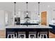 Stylish kitchen island with seating, pendant lighting, white backsplash, and ample counter space at 740 W County Road 10E, Berthoud, CO 80513