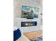 Elegant living room featuring a sleek, modern fireplace with a stone surround and a mounted television at 740 W County Road 10E, Berthoud, CO 80513