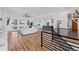 Bright open-concept living space with hardwood floors, leading to a modern kitchen and a cozy sitting area at 740 W County Road 10E, Berthoud, CO 80513