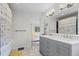 Bathroom with double sinks, gray vanity, tiled floors, and natural light at 1409 Quince Ave, Boulder, CO 80304