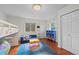 Bedroom with hardwood floors, a bunk bed, blue couch, and a playful atmosphere at 1409 Quince Ave, Boulder, CO 80304