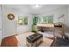 Inviting bedroom featuring a bunk bed, hardwood floors, and windows with green tree views at 1409 Quince Ave, Boulder, CO 80304