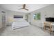 Bedroom featuring a ceiling fan, white walls, natural light and a view into an ensuite bathroom at 1409 Quince Ave, Boulder, CO 80304