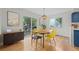 Light-filled dining area features modern lighting and a view of the backyard patio at 1409 Quince Ave, Boulder, CO 80304