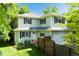 Charming two-story home featuring lush landscaping, a fenced yard, and an attached garage at 1409 Quince Ave, Boulder, CO 80304