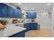 Modern kitchen with blue cabinets, white countertops, and stainless steel appliances at 1409 Quince Ave, Boulder, CO 80304