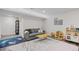 Cozy living room with gray couch, geometric rug, and play area at 1409 Quince Ave, Boulder, CO 80304