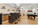Finished basement boasts a wet bar with bar seating and stylish lighting and pool table at 18027 E Ida Dr, Centennial, CO 80015